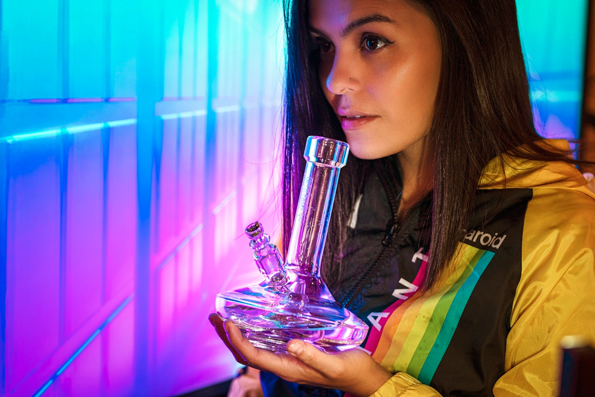 woman holding clear glass bong