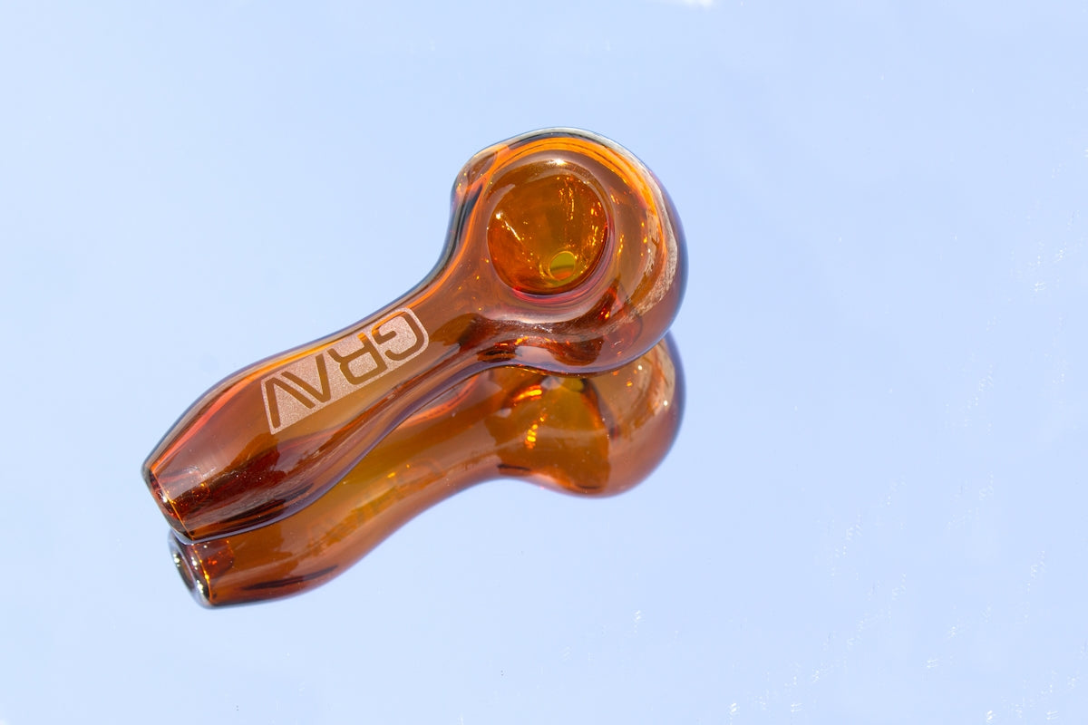 a close up of a glass object with a sky background