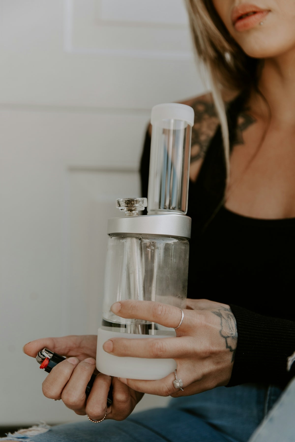 a woman holding a bottle of perfume in her hand