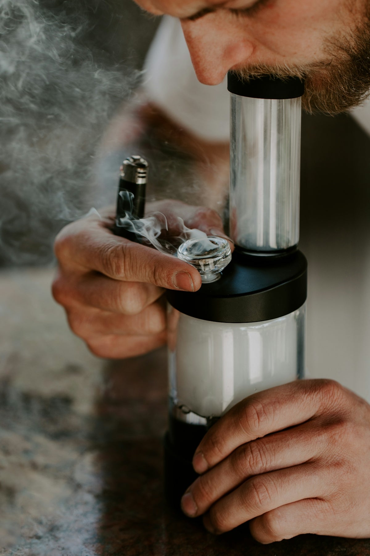 a man smoking a cigarette with a lighter in his hand