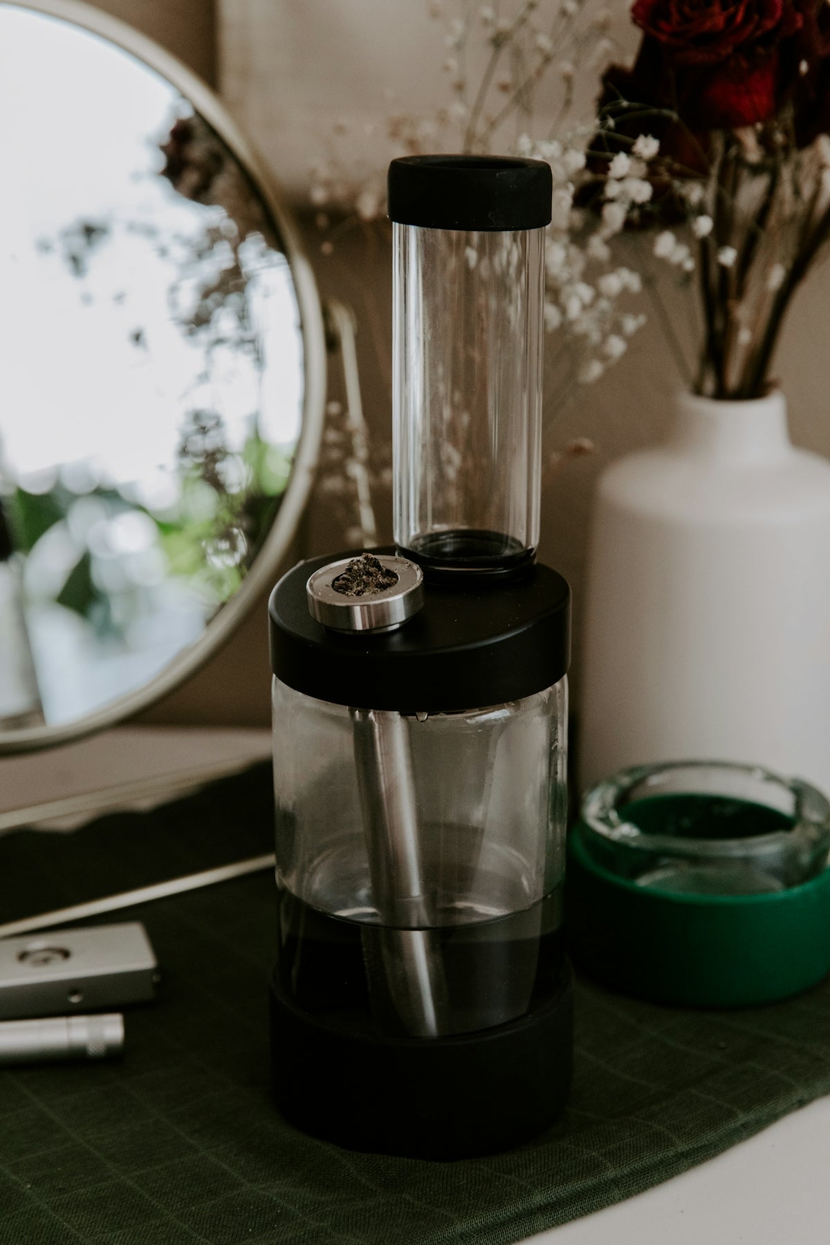 a blender sitting on top of a counter next to a mirror